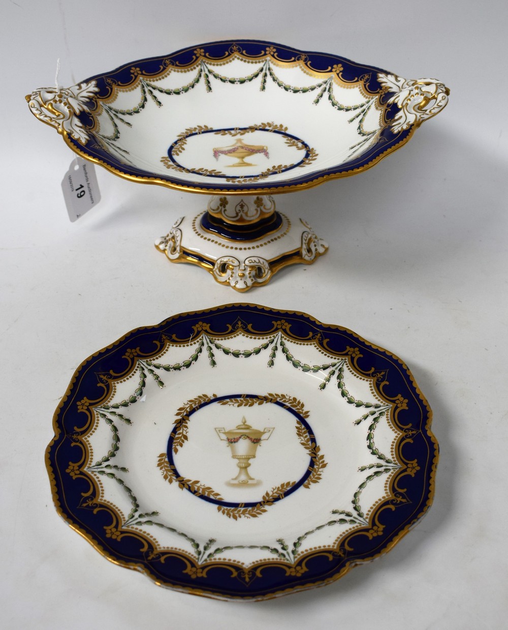 A Royal Crown Derby pedestal shaped oval comport, decorated with an urn within an oval cartouche,