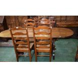 An oak trestle type dining table, stadium shaped top with fall leaves,