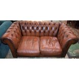 A Chesterfield type scroll arm reception sofa, deep button upholstery,