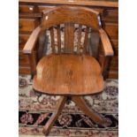 An early 20th century oak swivel office chair