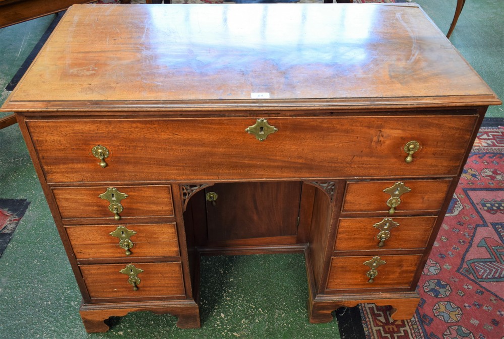 A George III mahogany kneehole desk, rectangular moulded top above a deep cockbeaded frieze drawer,