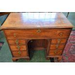 A George III mahogany kneehole desk, rectangular moulded top above a deep cockbeaded frieze drawer,