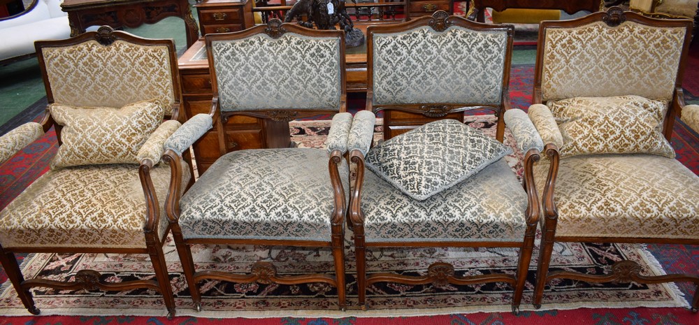 A set of four 19th century French drawing room armchairs, stuffed over upholstery, scroll arms,