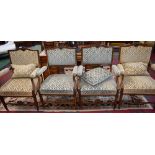 A set of four 19th century French drawing room armchairs, stuffed over upholstery, scroll arms,