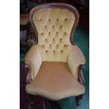 A Victorian mahogany spoon back armchair, stuffed over deep buttoned upholstery, carved scroll arms,