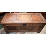 A Charles II oak three panel blanket chest, hinged top above a nulled frieze, enclosing a till,