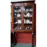 A Victorian mahogany console bookcase, outswept cornice above a pair of glazed doors,