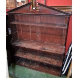 A George III mahogany open bookcase, broken arch pediment above an arrangement of shelves,