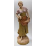 A Royal Dux figure, of a lady holding corn in her aprons and under her arm, in burnished gilt,