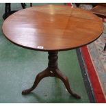 A George III mahogany tripod occasional table, circular tilting one piece top, turned pillar,