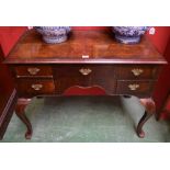 A George I Revival crossbanded walnut lowboy, quarter veneered top above five frieze drawers,