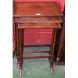 A George III Revival mahogany nest of three occasional tables, turned slender end supports,