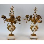 A pair of Louis XV style gilt metal and marble three branch candelabra,