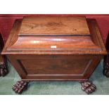 A Regency mahogany sarcophagus cellaret, hinged cover, panelled sides, bold lion paw feet,