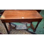 A 19th century mahogany writing table, oversailing top above a long frieze drawer,