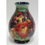 A Moorcroft Finches pattern baluster vase, tube lined with birds perched amongst ripe fruit,