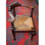 A George III Revival corner elbow chair, curved cresting rail terminating in scroll hand rests,