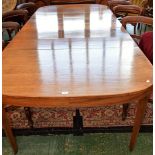 A Sheraton Revival mahogany extending dining table, stadium shaped top with five additional leaves,