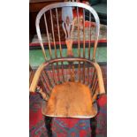 A Country House Windsor elbow chair, shaped and pierced splat, bowed arm rail, saddle seat,