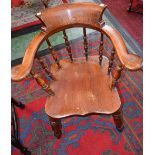 A Victorian elm smoker's bow elbow chair, bowed arm rail terminating in outswept hand rests,