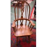 A Country House Windsor type elbow chair, central wheelback splat,