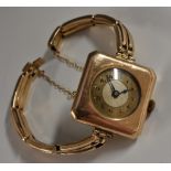 A George V Art Deco 9ct gold canted square cased bracelet watch, two tone circular dial,