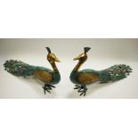 A pair of cast metal models of peacocks,