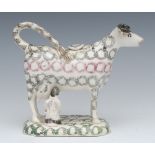 A 19th century cow creamer and cover, standing four square, with milkmaid,