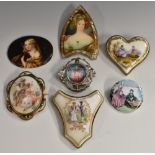 A late 19th century porcelain heart brooch, decorated with a seated lady and child within landscape,