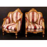 A pair of Louis XVI style gilt softwood armchairs, stuffed-over silk upholstery with claret,