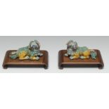 A pair of Chinese spinach and egg glazed porcelain models, of temple lions,