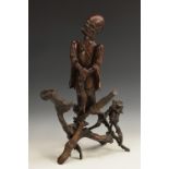 A Chinese rootwood figure, carved as an immortal holding a fly whisk, 53cm high,