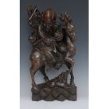 A Chinese hardwood carving, of a scholar riding on a stag, a monkey clinging to the back,