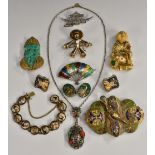 Oriental Jewellery - a carved green glass jade effect and cast metal clip brooch,