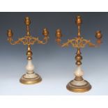 A pair of Gothic Revival gilt metal and alabaster three-light candelabra,