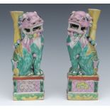 A pair of Chinese stoneware polychrome Dogs of Fo, in pink, green and yellow, 23.