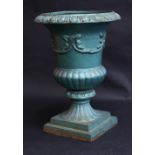 A cast iron fluted campana shaped garden urn, egg and dart border and socle, stepped square base,