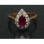 A ruby and diamond pear drop cluster ring, central pear drop red ruby approx 0.