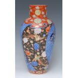 A Japanese Kutani vase, decorated in polychrome with panels with birds of paradise amongst flowers,