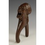 A Black Forest lever-action novelty nut cracker, carved as the head of a lady, 21cm long,