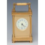 A French gilt metal carriage clock, the white dial with blue Arabic numerals,