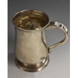 A George II Provincial silver bell shaped mug, flared rim, scroll handle, skirted base, 12.