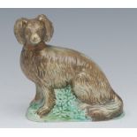 An early 19th century model, of a dog, green moulded base, 9.5cm high, c.