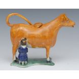 A 19th century cow creamer and cover, standing four square, with milkmaid, in tan,