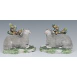 A pair of French models, of sheep, reclining before bocage, shaped bases, 9cm high, c.