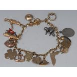 A lady's 9ct gold charm bracelet, stirrup, gramophone, Mr Punch, dog and dog collar charms, etc,