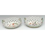 Two early Derby Patch Mark 'spectacle' baskets, painted in polychrome with ripe fruits, butterflies,