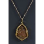 An unusual Buddistic bronze and gold pendant necklace, shaped bronze panel monk seated at prayer,