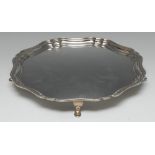 A George II design shaped circular salver, quite plain, pad feet, 25.