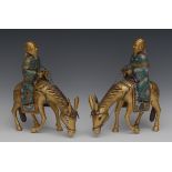 A pair of 19th century Chinese cloisonné models of scholars riding donkeys,